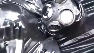 Latex Girl Full in Black Rubber and Gasmask Chill Outs Outdoor in Garden in a Heavy Rubber Hammock