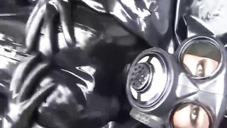 Latex Girl Full in Black Rubber and Gasmask Chill Outs Outdoor in Garden in a Heavy Rubber Hammock