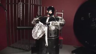 Blonde Girl in Black Latex Catsuit Full Encased in Inflatable Rubber and Full Body Plastic Suit