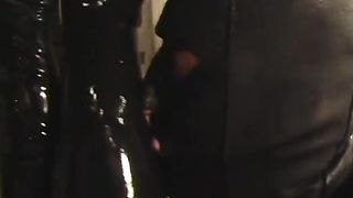 Sexy dominatrix in red leather makes a guy do her wishes