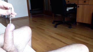 Close up for full insertion of 9 '' sounding rod into urethral peehole