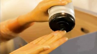 Woman puts on latex condom suit